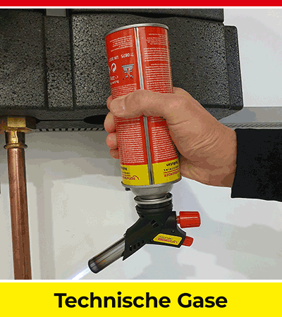 Hand hält Gasflasche für technische Anwendungen