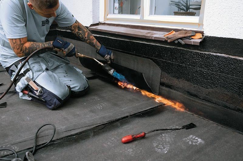 Sievert PRO 88 Brenner im Einsatz zur Abdichtung von Dächern mit Bitumenbahnen Handwerker verwendet Sievert PRO 88 Brenner zum Verschweißen von Dachbahnen